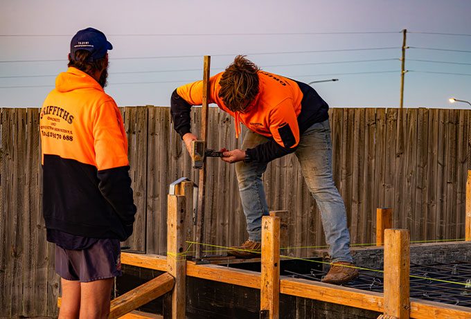 Men Fixing Fence — Concreting Services Toowoomba, QLD